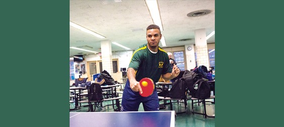 Bronx High School of Science senior Roger Arrieux practices table tennis with his teammates before a 5-0 victory over John Bowne High School at Bronx Science on Monday -Photo by Adrian Fussell